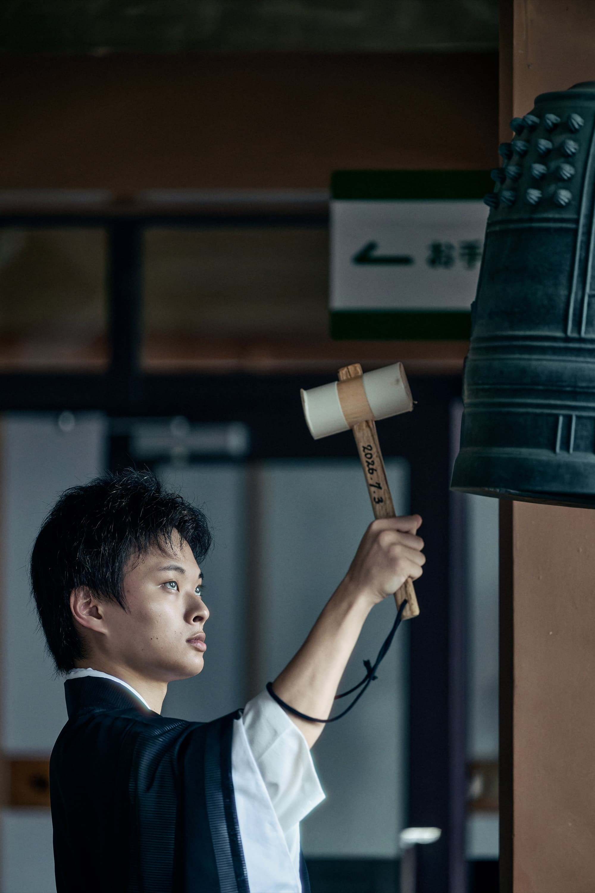 鐘を撞く人物