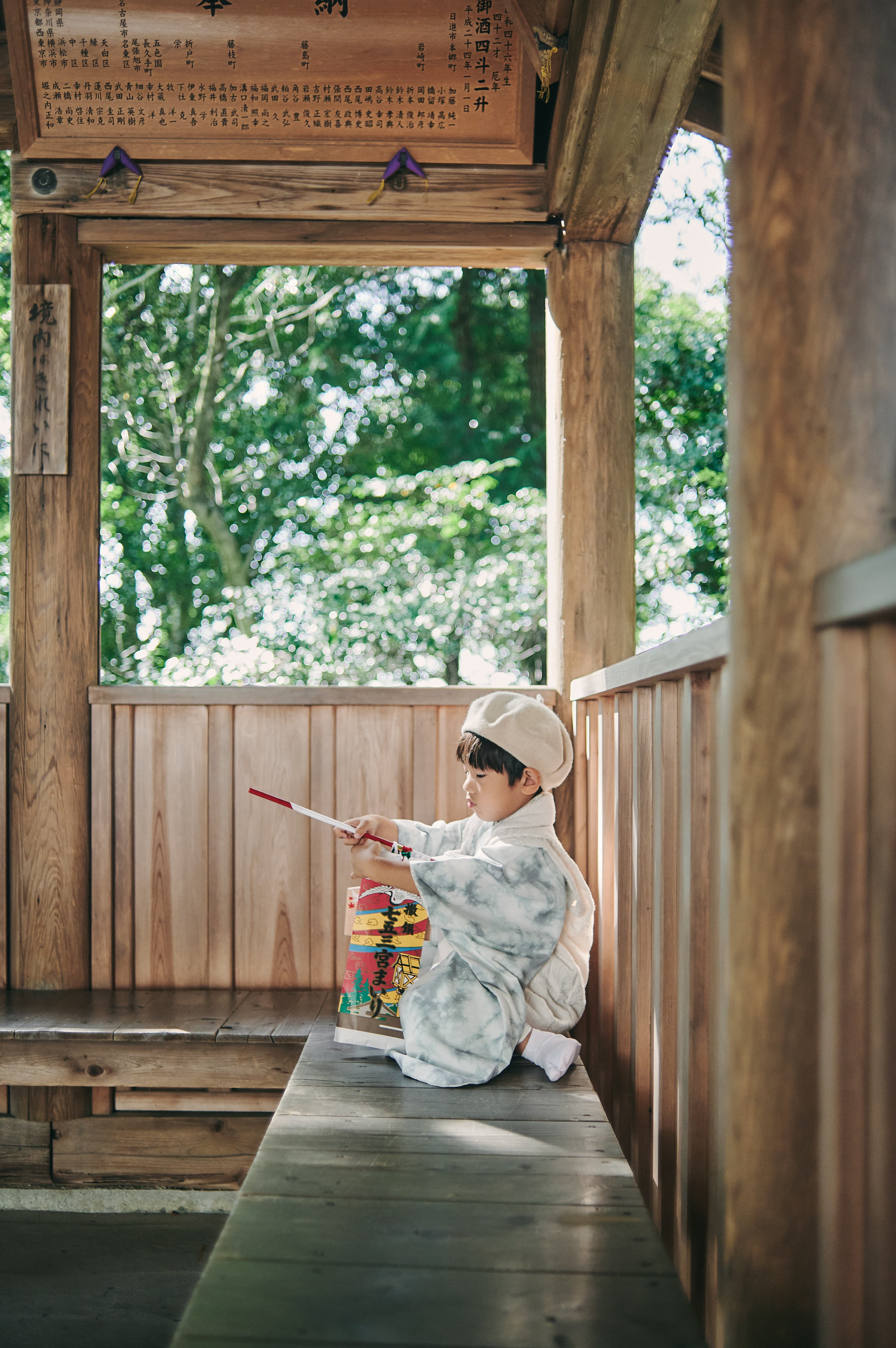 木の縁側に座る子ども